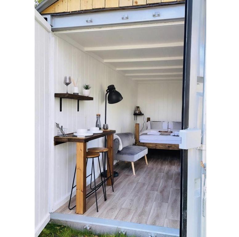 a tiny house with a desk and a room at Trethowels Grey Hidden hut in St Austell