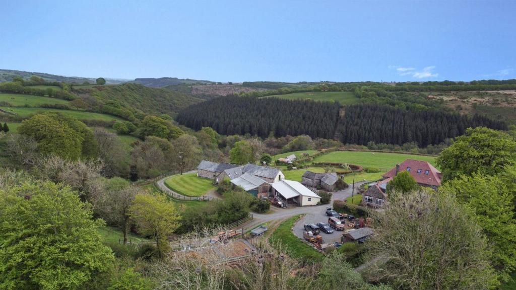 an aerial view of a village in the hills at West Hollowcombe Farm Cottages - full site booking in Dulverton