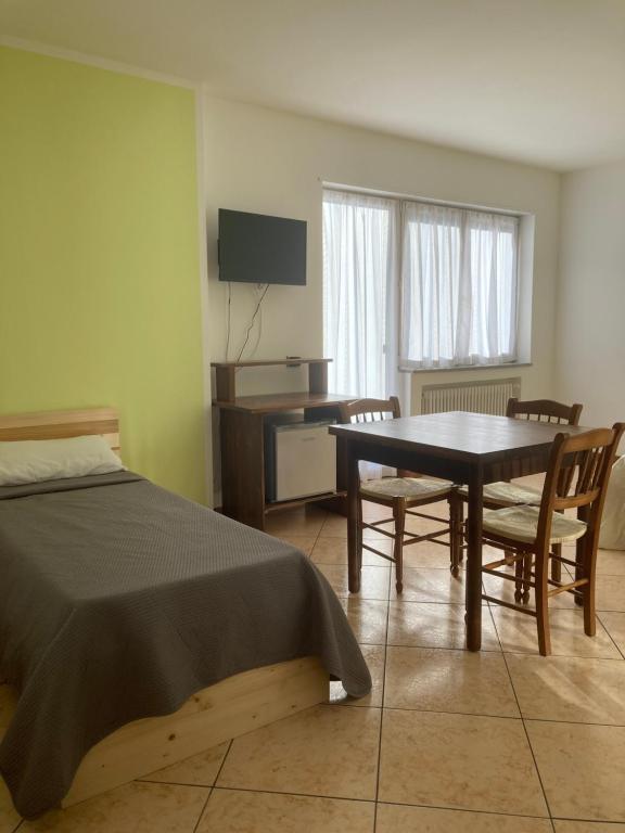 um quarto com uma cama, uma mesa e uma secretária em Lavini em Marco
