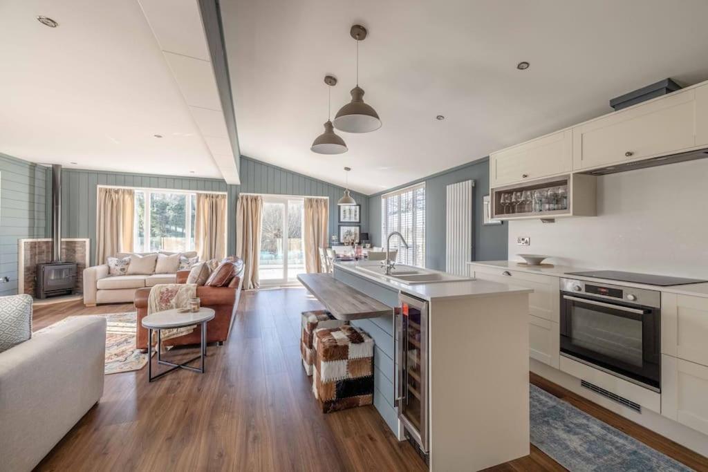 a kitchen with a counter top and a living room at Waterfront Lodge Windsor Racecourse Marina in Windsor