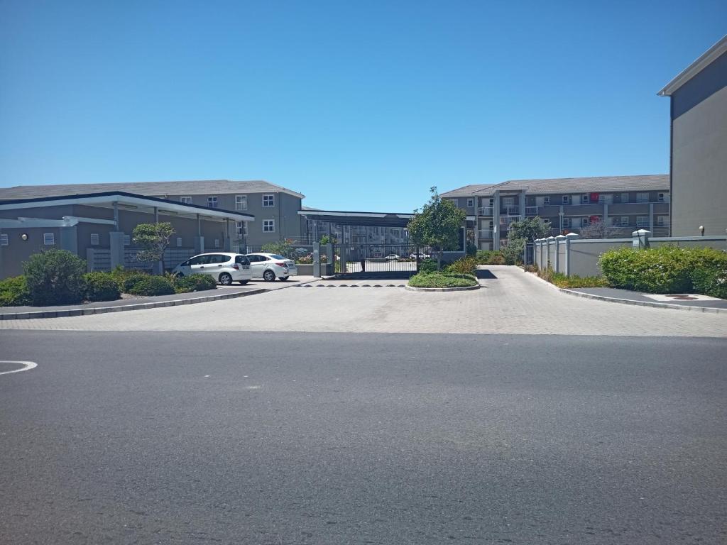 a parking lot with a car parked in a building at Dune Crest - 2 Bedroom Apartment in Cape Town