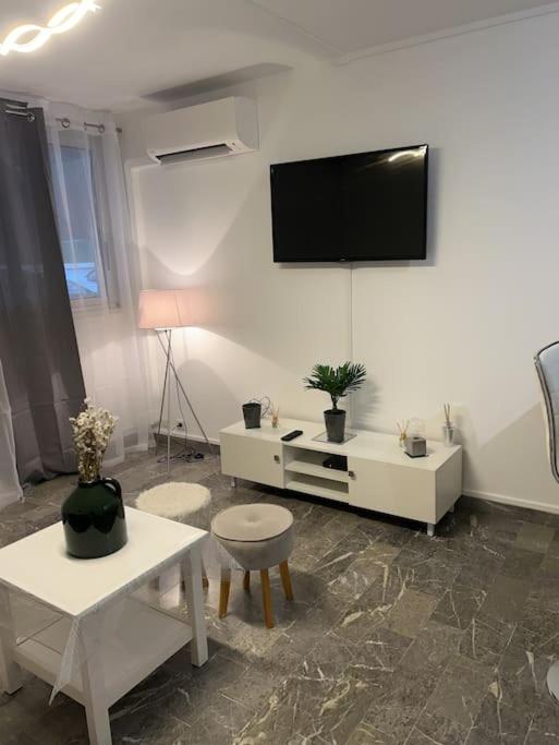 salon z telewizorem na ścianie w obiekcie Chez Julien & Ornella w mieście Saint-Laurent-du-Var