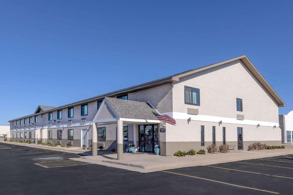 an empty parking lot in front of a building at Super 8 by Wyndham Pratt in Pratt