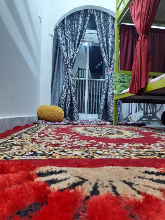 a room with a rug on the floor and a window at Ali Baba Hostel in Jaipur