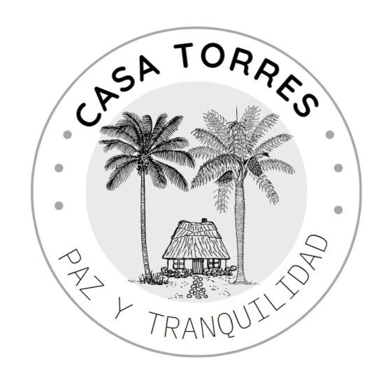 a black and white logo for a travel company with palm trees at Casa Torres in San Bartolomé de Tirajana