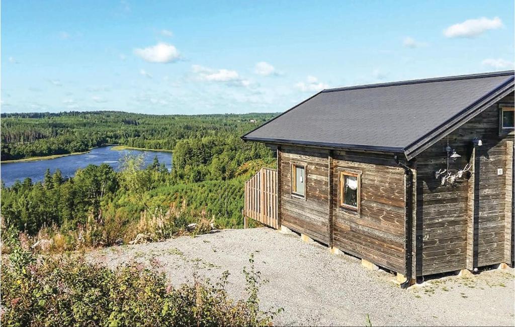 a wooden cabin with a view of a river at 2 Bedroom Awesome Home In Vetlanda in Vetlanda