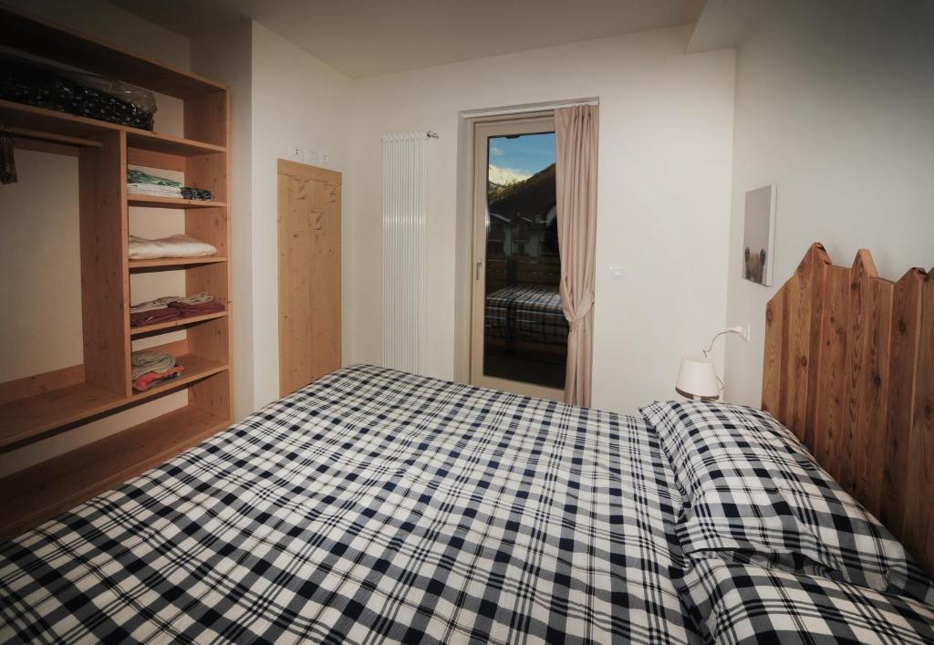 Postel nebo postele na pokoji v ubytování Appartamenti Residence Lares Ossana