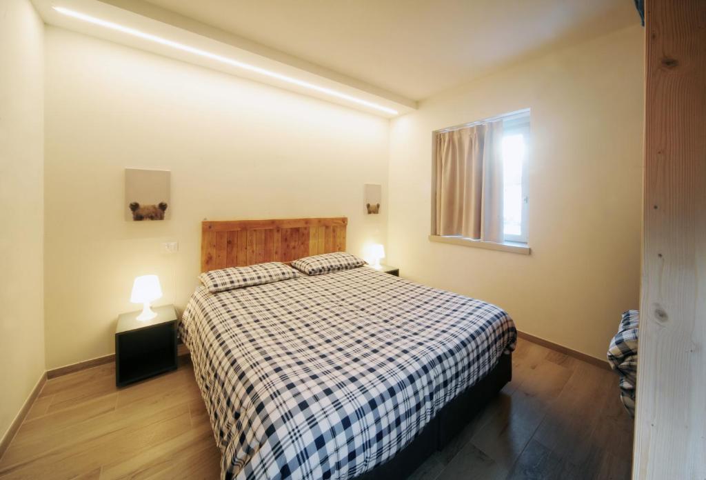 Postel nebo postele na pokoji v ubytování Appartamenti Residence Lares Ossana