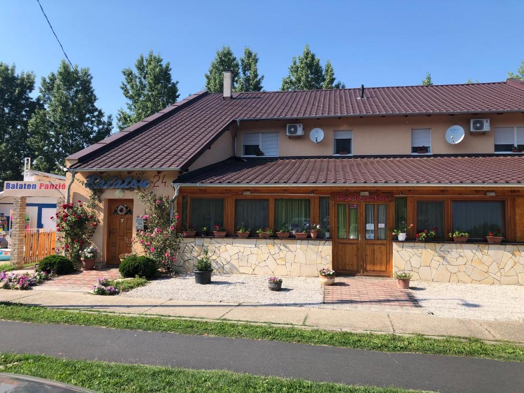 a house with a brown roof at Balaton Panzió in Balatonberény