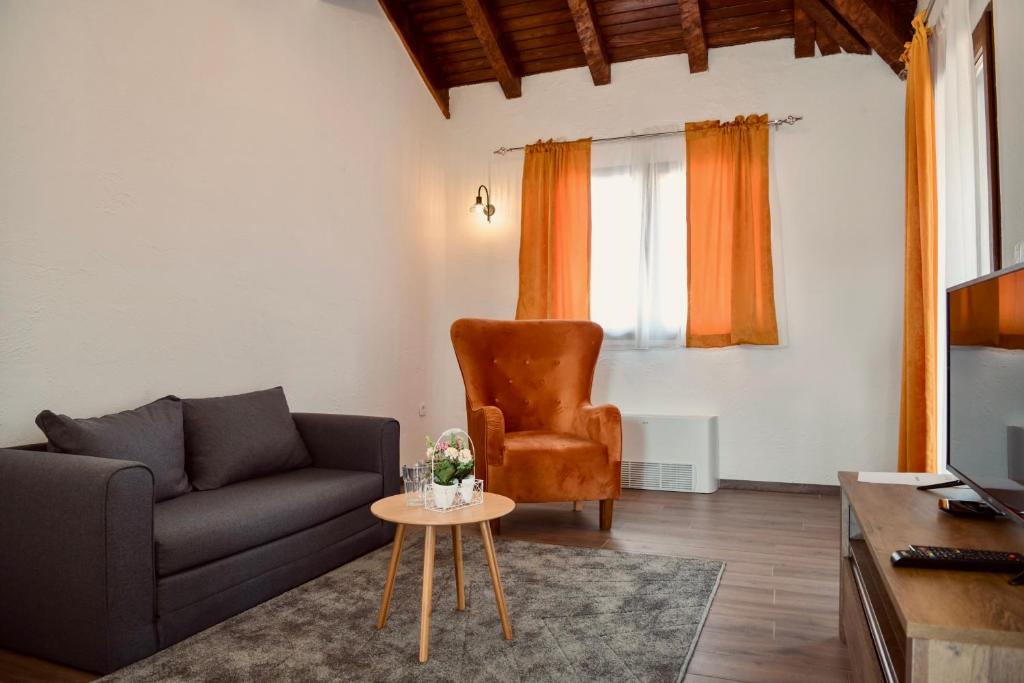a living room with a couch and a chair at Varoš Čaršija in Trebinje