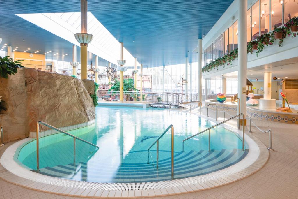 a large swimming pool in a large building at Holiday Club Turun Caribia in Turku