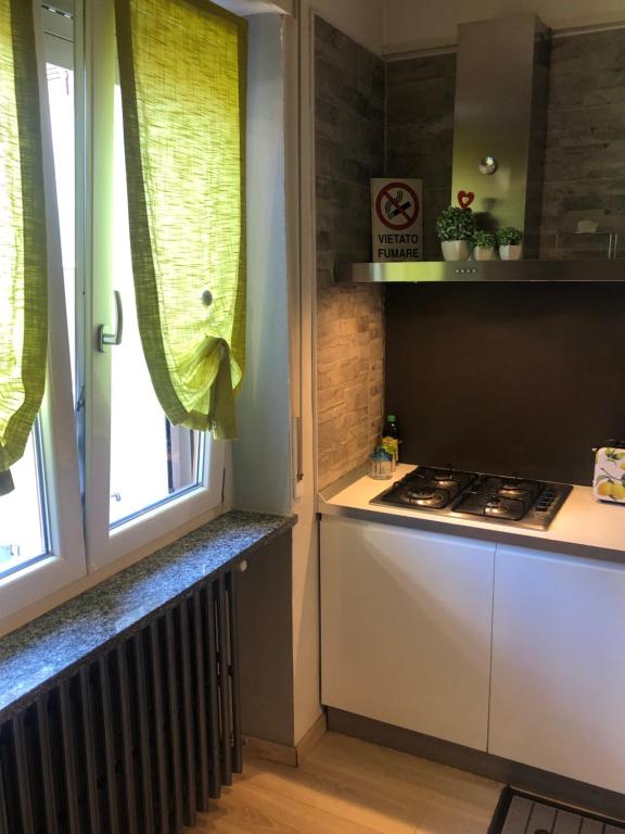 a kitchen with a stove and a window at "La Bella della Cappuccina" Casa con Parcheggio Interno Gratuito in Domodossola