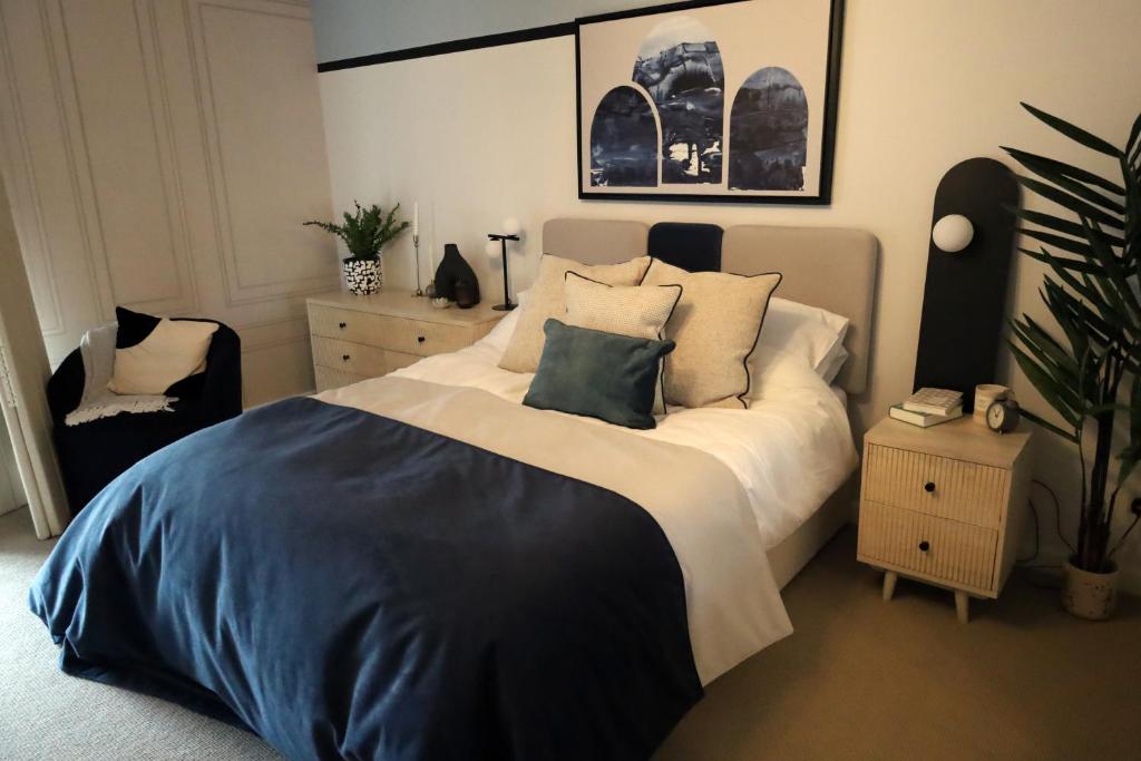 a bedroom with a large bed with pillows on it at Wesley House in Cheltenham