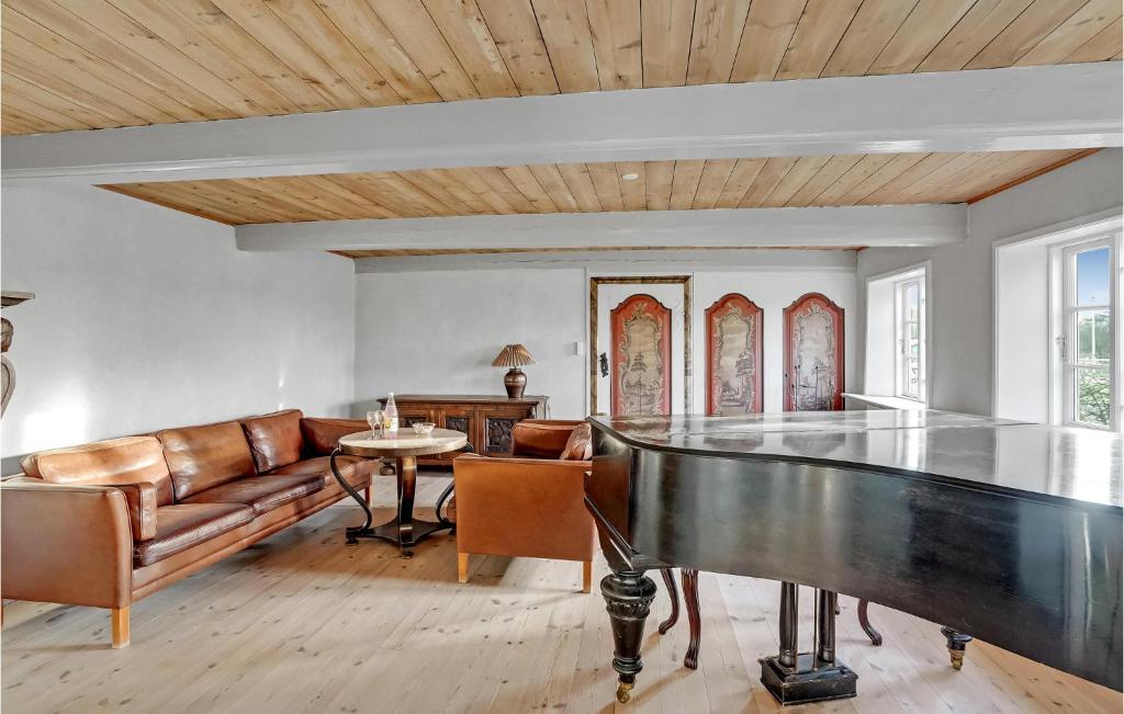 a living room with a ping pong table and a couch at 8 Bedroom Beautiful Home In Hjer in Højer