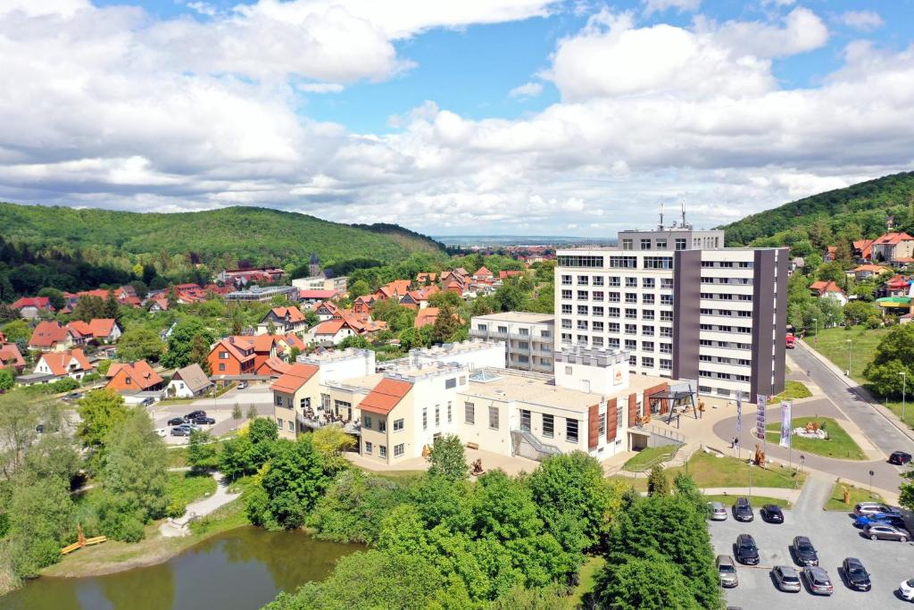 an aerial view of a town with a river and buildings at Hasseröder Burghotel in Wernigerode