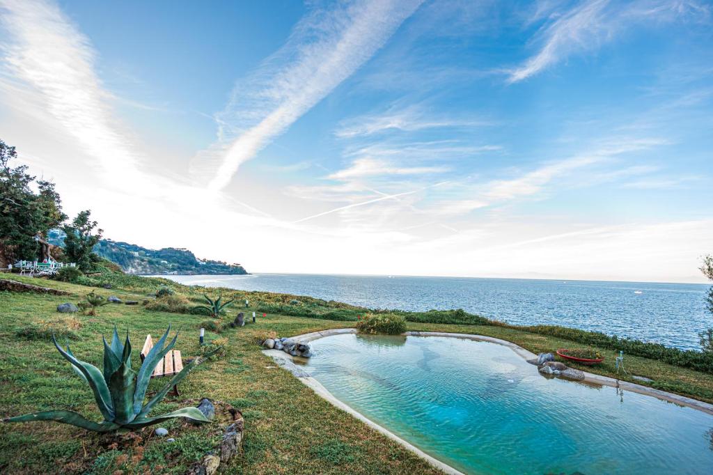 a swimming pool with the ocean in the background at Villa Serao by MyVillaCollection in Ischia