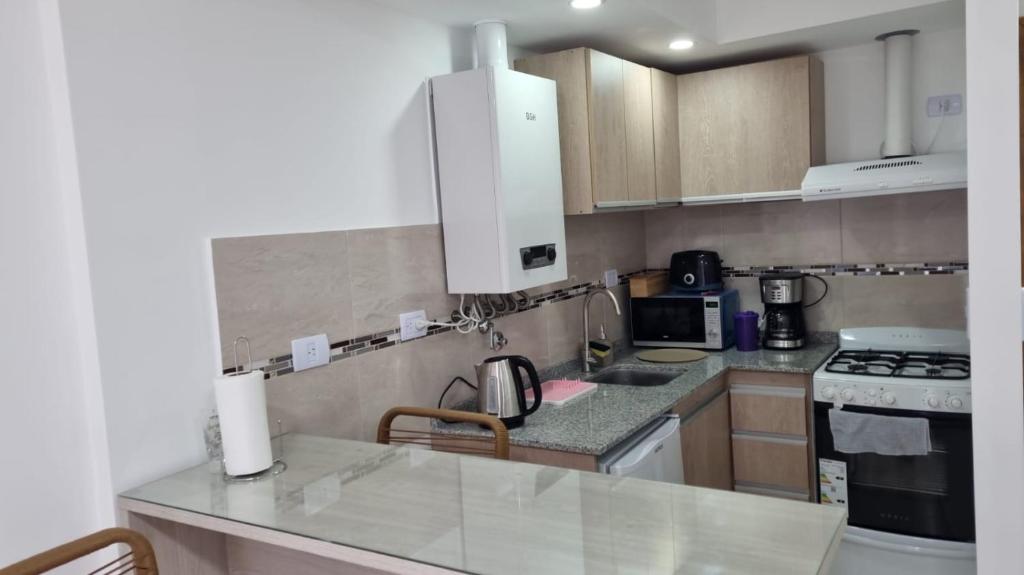 a kitchen with a counter top and a stove top oven at Los argentos in Ushuaia