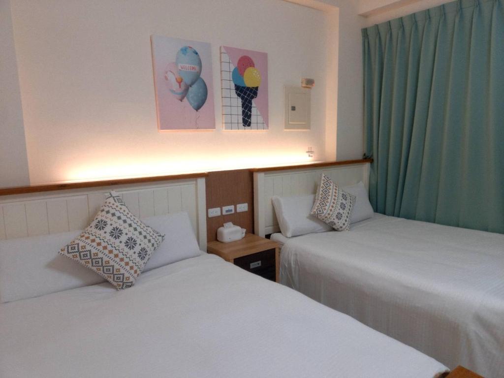Postel nebo postele na pokoji v ubytování 墾丁慕欣旅店