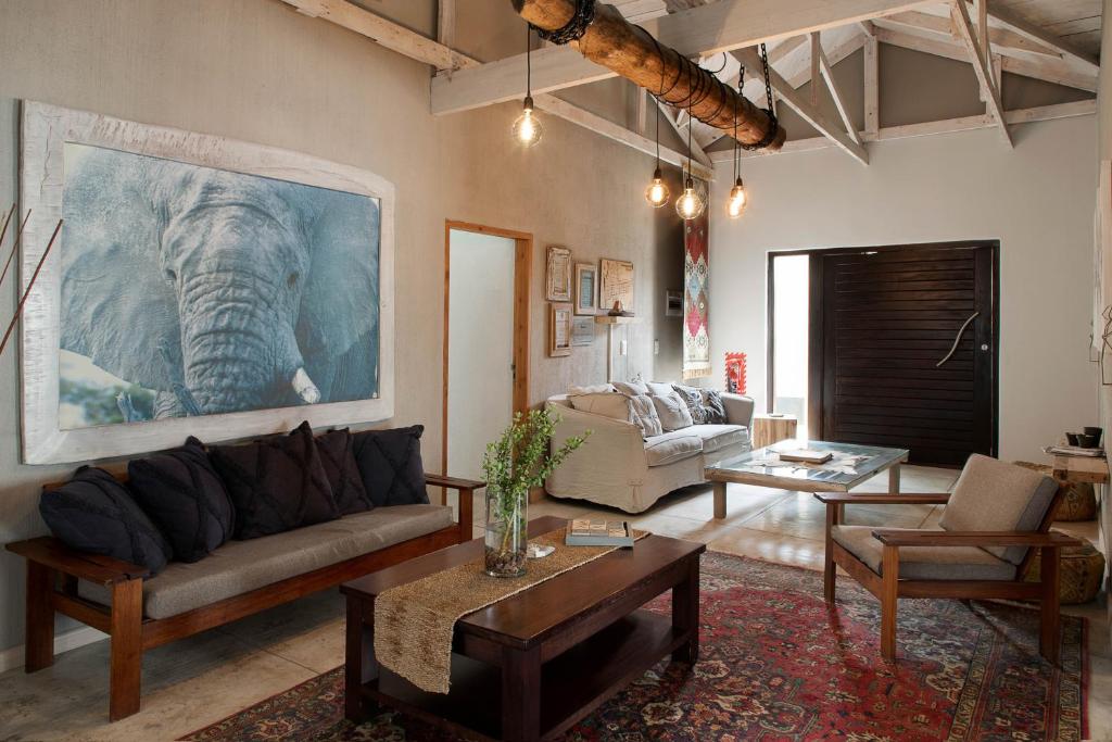 a living room with an elephant painting on the wall at Atlantic-Square Guesthouse in Swakopmund