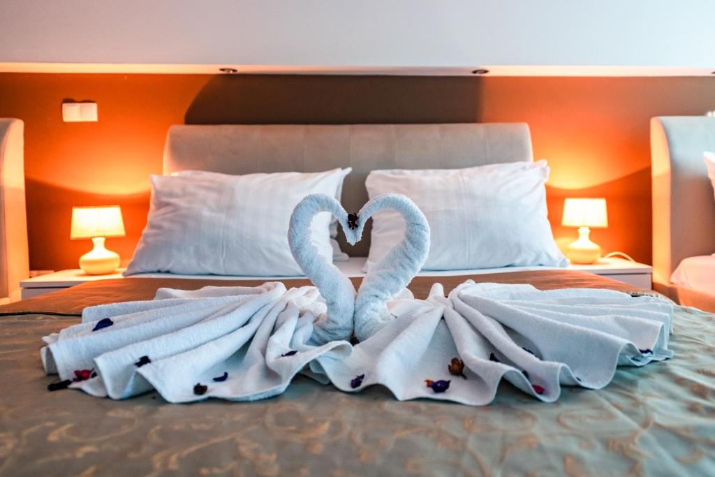 two swans made out of towels on a bed at Hotel Oasis in Mostar
