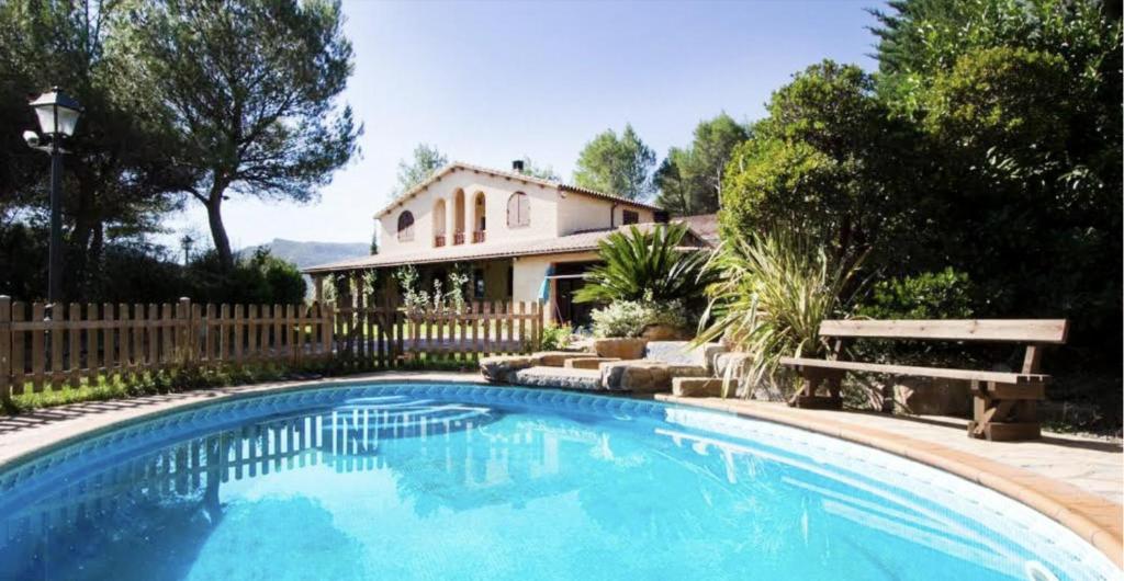 a large swimming pool in front of a house at Catalunya Casas Peaceful Perfection , only 30km from Barcelona! in Vacarisas
