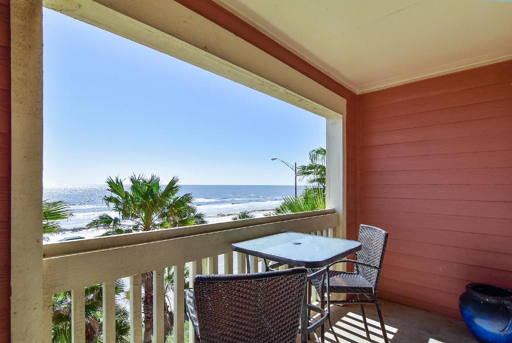balcón con mesa, sillas y vistas al océano en Dawn 631 en Galveston