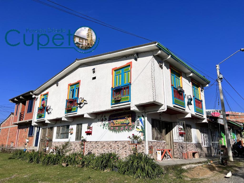 a building with colorful doors and windows on it at Posada Dónde Cupeto in Salento