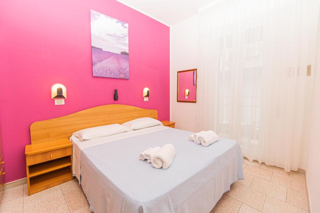 Postel nebo postele na pokoji v ubytování Hotel Arlino
