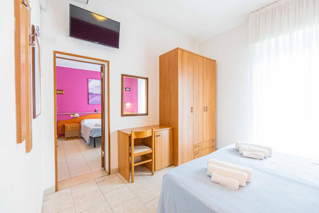 Postel nebo postele na pokoji v ubytování Hotel Arlino