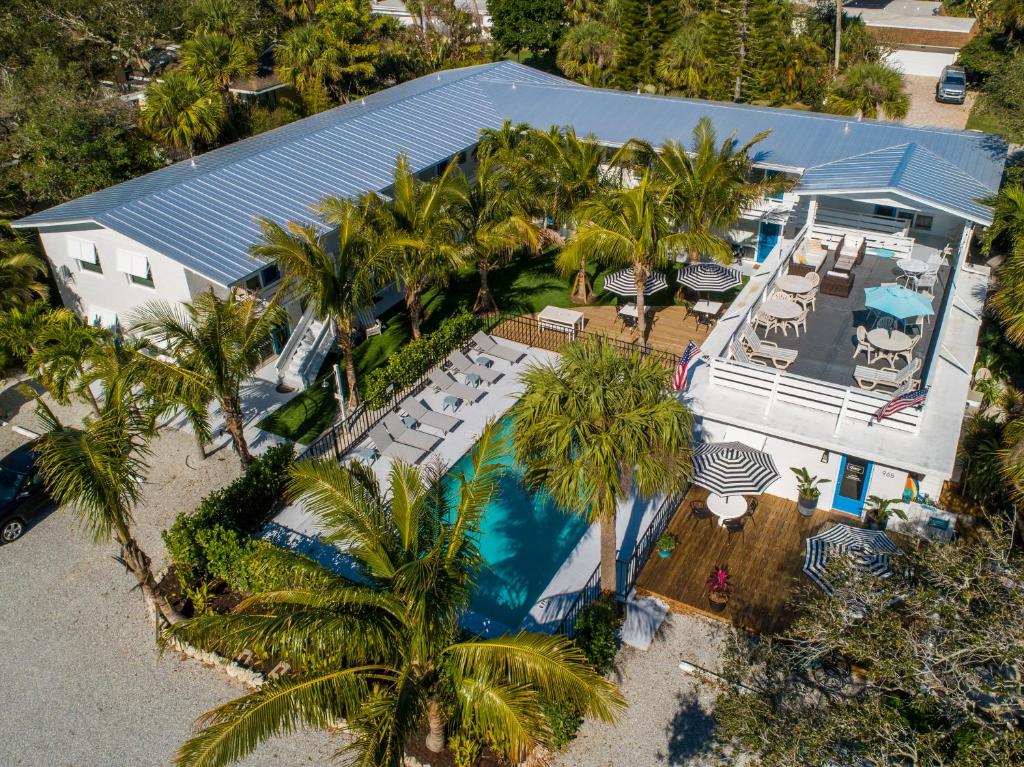 an overhead view of a house with a pool and palm trees at Seaspray Surf Lodge in Vero Beach