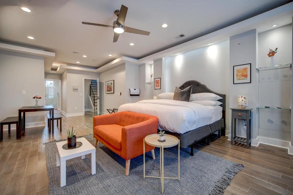 a bedroom with a king sized bed and a orange chair at Artsy Hidden Gem ll -Free Parking --- in Philadelphia