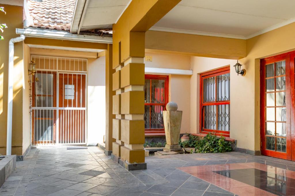 a lobby of a building with yellow and red doors at Harmony Bay Tranquility Base in Johannesburg