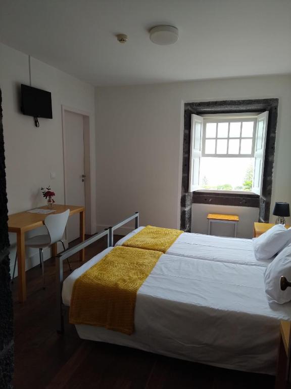 Ένα ή περισσότερα κρεβάτια σε δωμάτιο στο Azores Youth Hostels - Pico