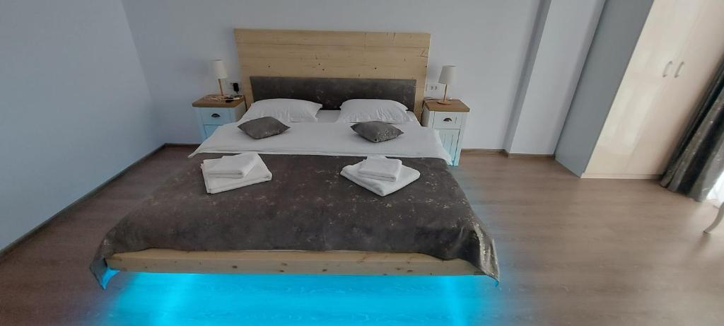 a bedroom with two beds in a room with a blue at HAPPY SUMMER -Predeal in Predeal