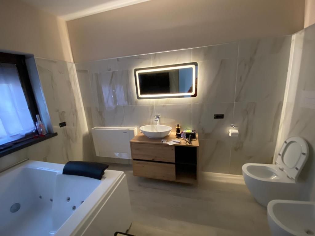 a bathroom with a tub and a sink and a bath tub at B&B Il Sogno Cosenza in Cosenza