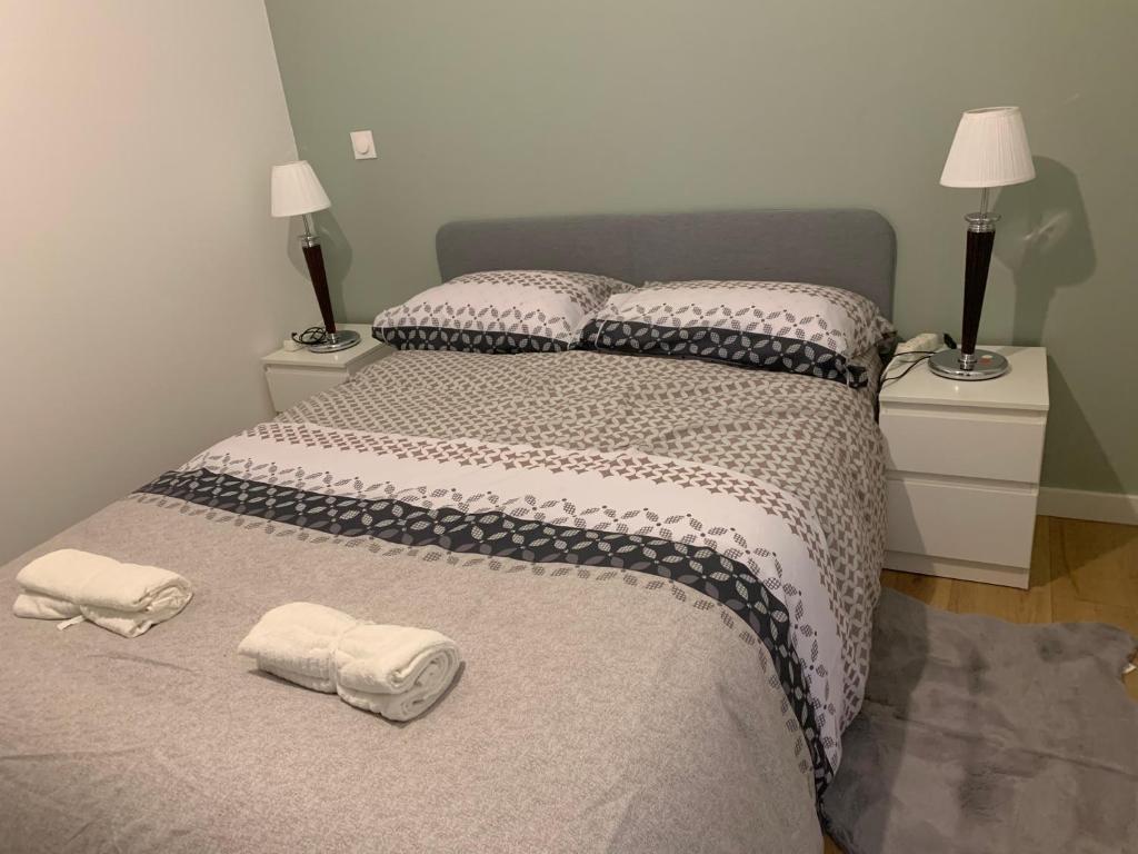 a bedroom with a bed with two towels on it at Appartement F2 Orly Aéroport in Paray-Vieille-Poste