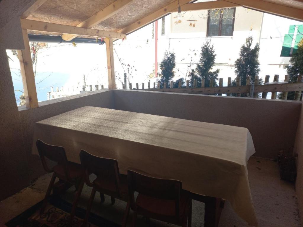 a table and chairs in a room with a large window at HOUSEHOLD MIKO MERDOVIC - 15e per person in Berane
