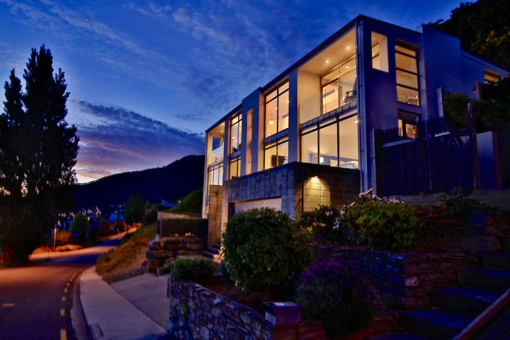 a large house is lit up at night at Spectacular Panoramic 5Bedroom Lakeview in Queenstown