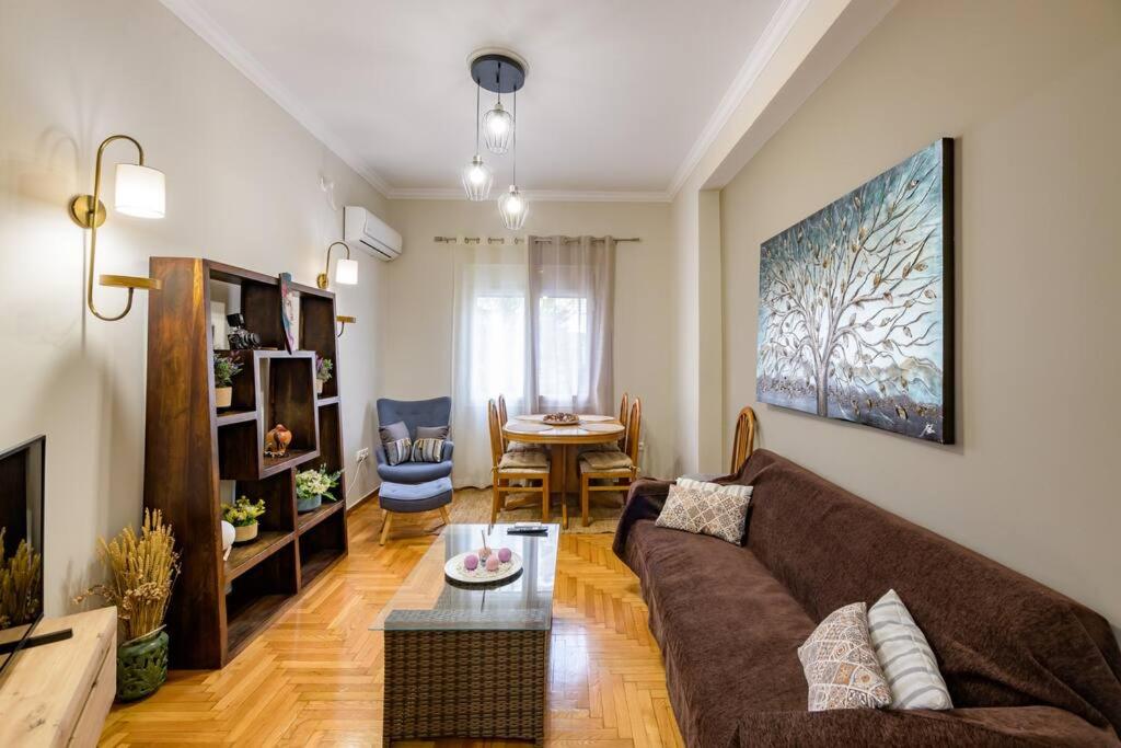 a living room with a couch and a table at Fully renovated flat close to Uni & hospitals in Athens