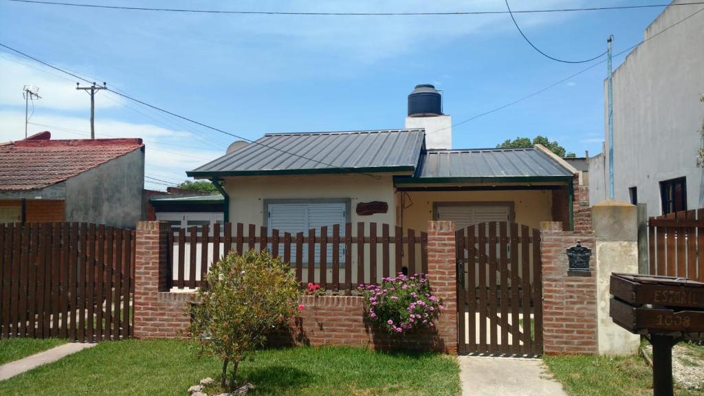a house with a wooden fence in front of it at La Casita in Santa Clara del Mar