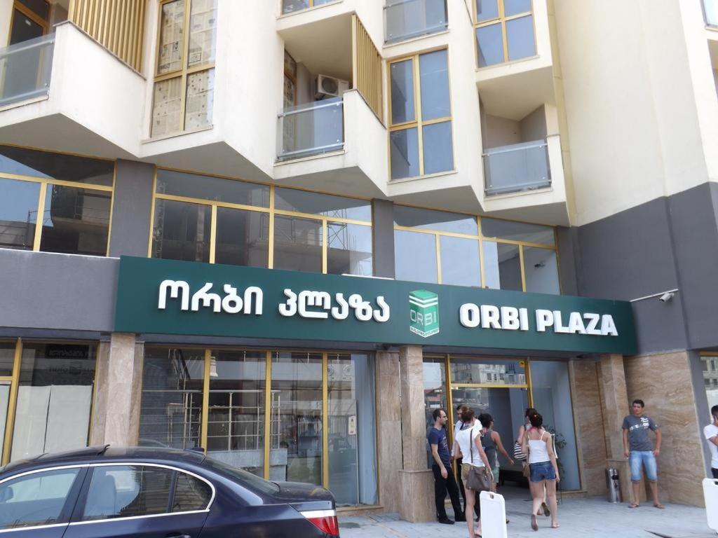 eine Gruppe von Personen, die außerhalb eines Gebäudes stehen in der Unterkunft Apartment Orbi Plaza in Batumi