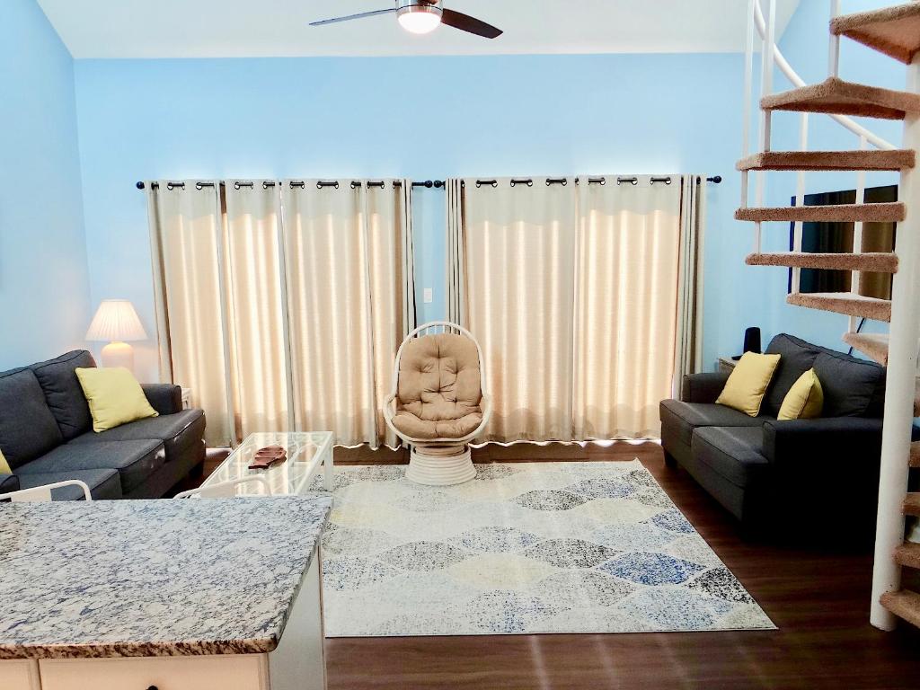 a living room with a couch and a chair at A Wave From It All-5J GCR in Myrtle Beach