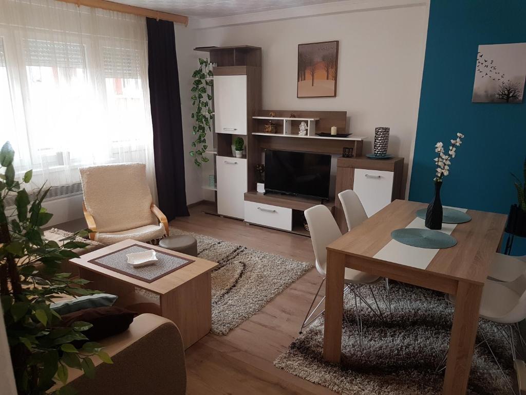 a living room with a table and a television at APARTMAN PARK in Šabac
