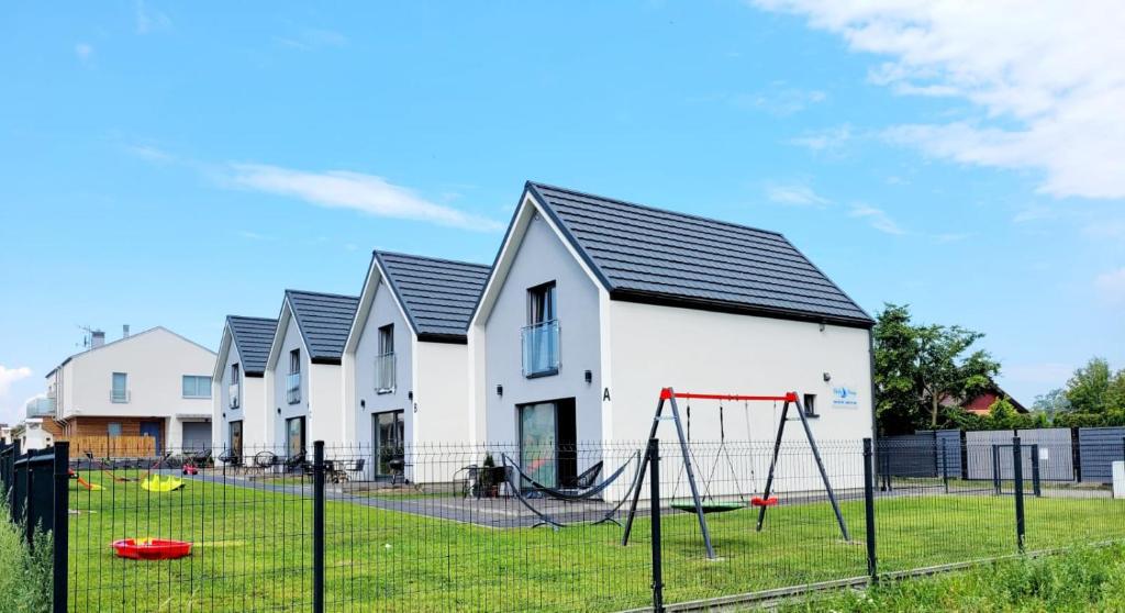 a house with a playground in front of it at Baltic Breeze in Władysławowo