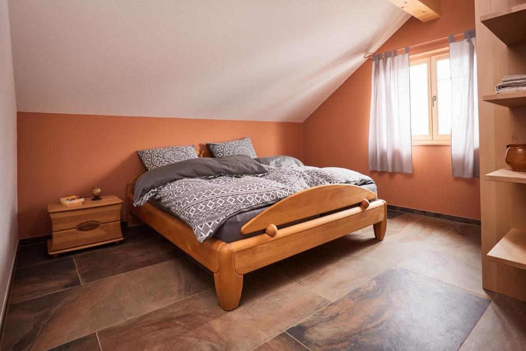 a bedroom with a bed with a wooden frame at Biopension Satya in Offenburg