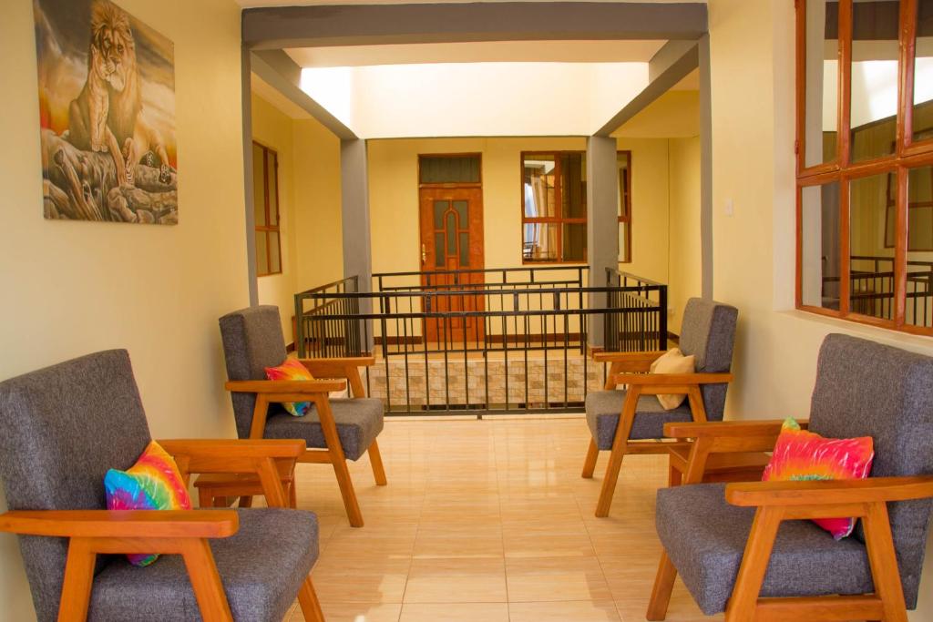 a waiting room with chairs and a balcony at Hecasa Homestay in Arusha