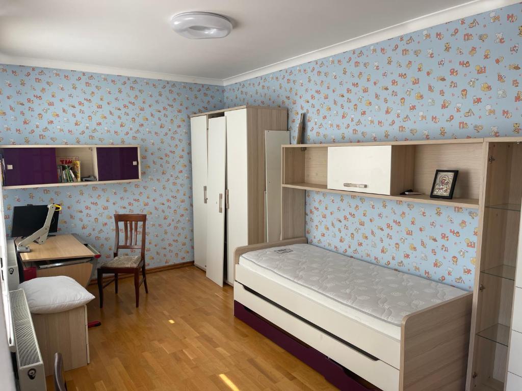 Lux House في تشيرنيفتسي: غرفة نوم مع سرير بطابقين مع مكتب ومكتب