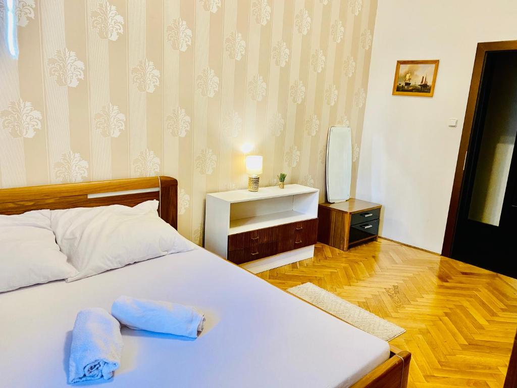 a bedroom with a bed and a tv in it at Hotel Room in Praha 2 Square in Prague