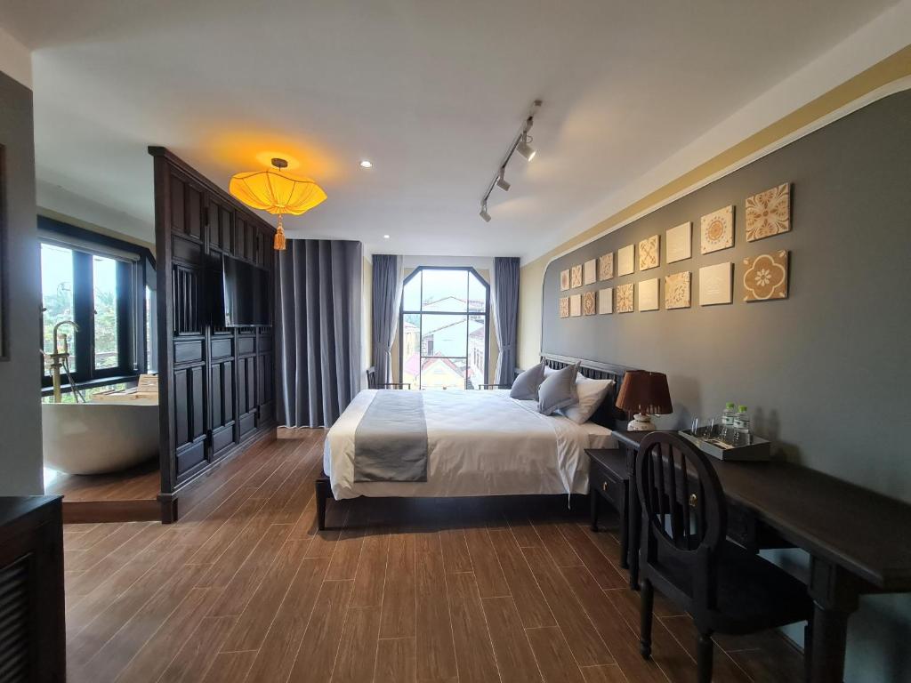 Postel nebo postele na pokoji v ubytování Hoianan Boutique Hotel