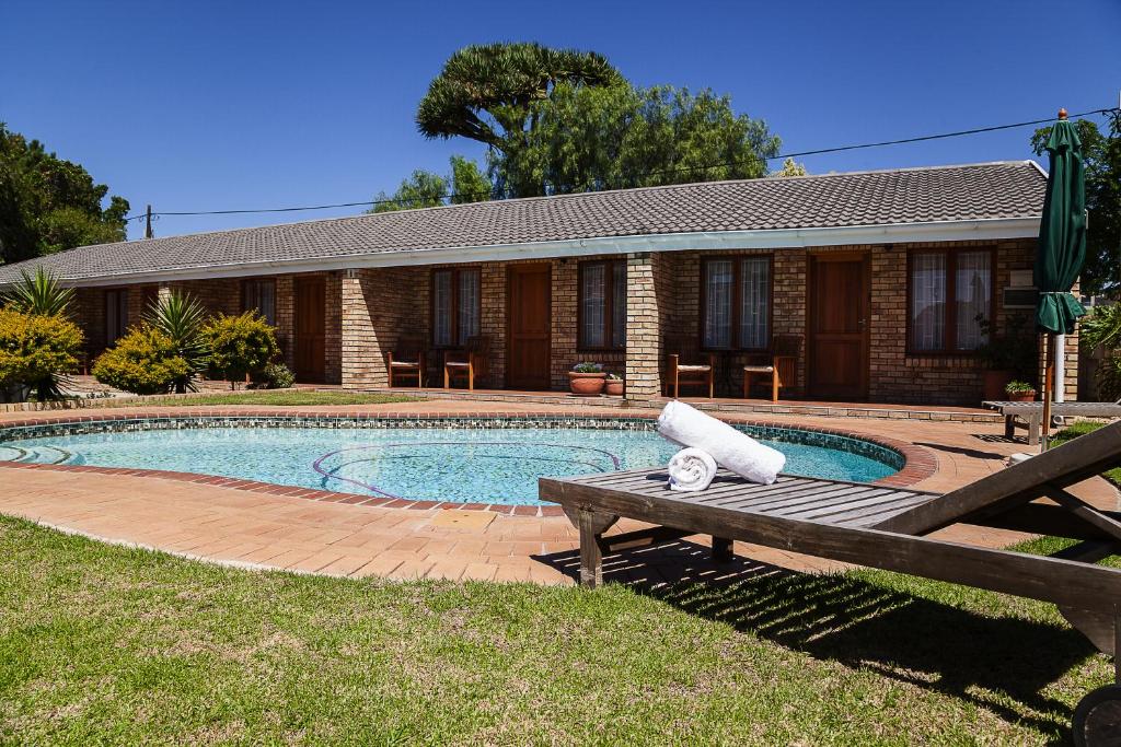 a house with a swimming pool in the yard at Newton Sands Guesthouse in Port Elizabeth